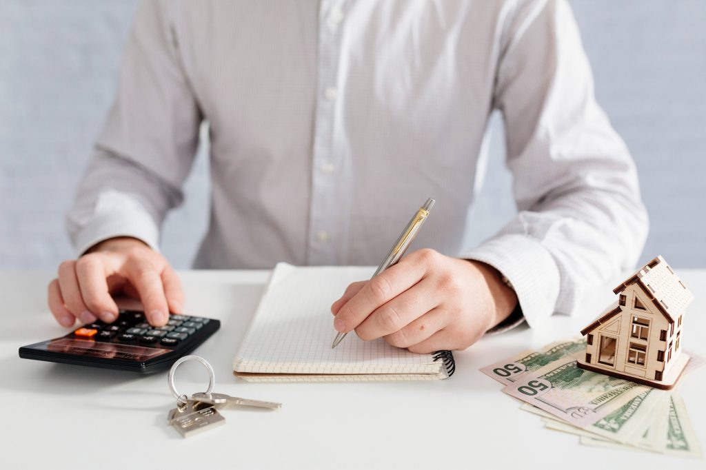 Man reviewing financial documents and calculating figures, representing CMBS loans